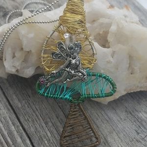 fairy sitting on a mushroom wire wrapped pendant